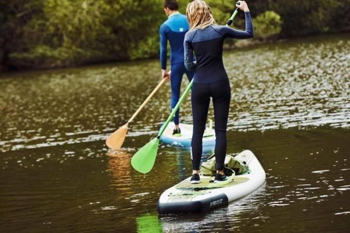 a person riding a surf board on a body of water