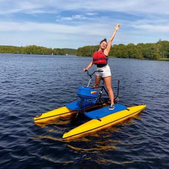 a man riding on the back of a boat in a body of water