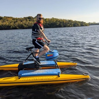 a man riding on the back of a boat in a body of water