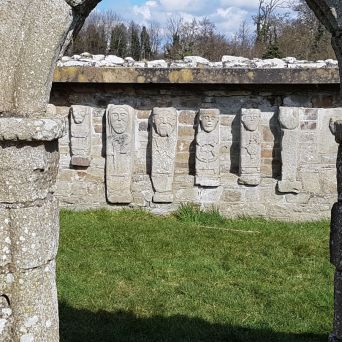 a stone building that has a sign on a brick wall