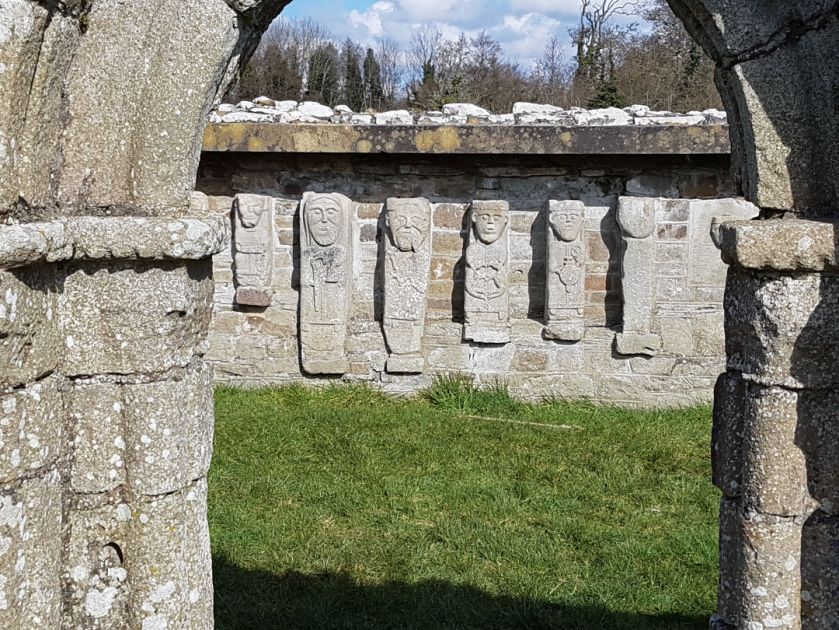 a stone building that has a sign on a brick wall