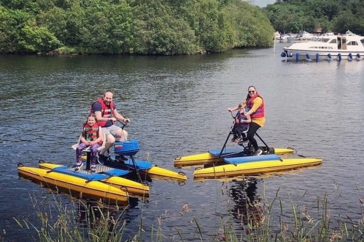 a group of people in a small boat in a body of water