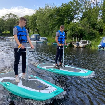 a group of people riding on the back of a boat