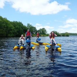 a group of people riding on the back of a boat in the water