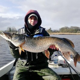 a man holding a fish in the water